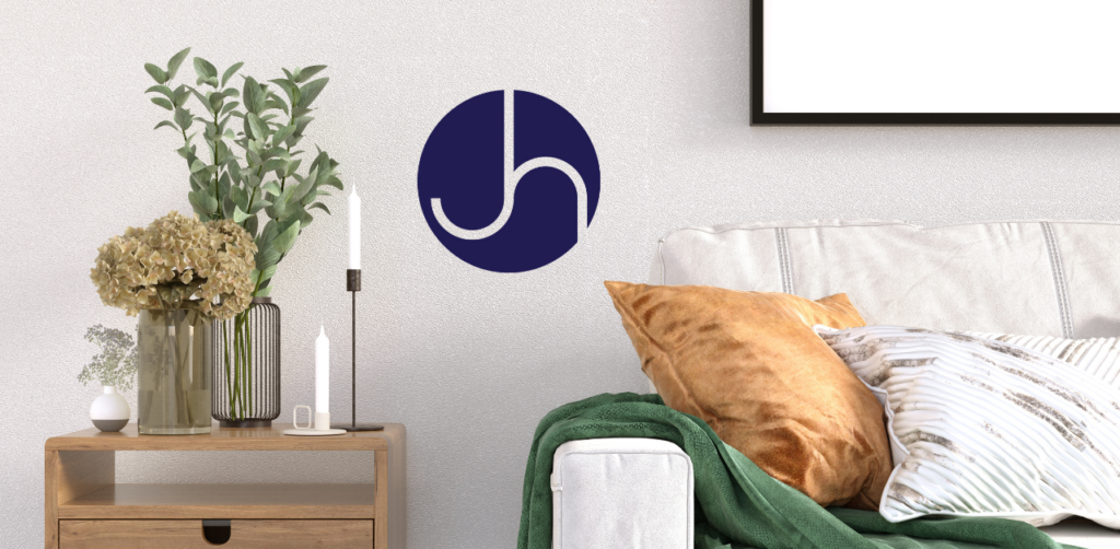 A couch and a table with Janice Hall logo
