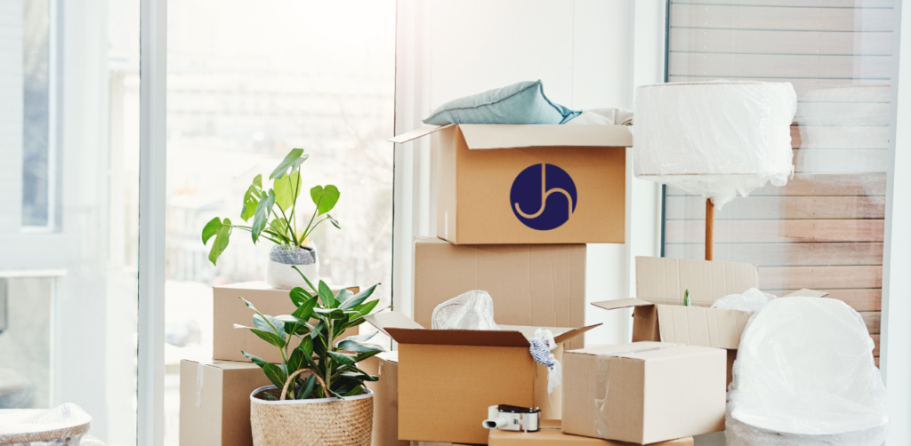 Moving boxes with a Janice Hall logo